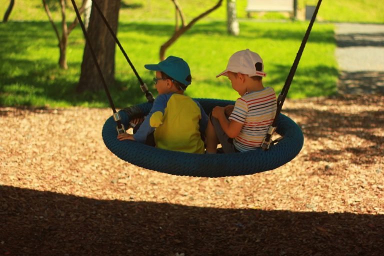 Children playing on outdoor playground equipment