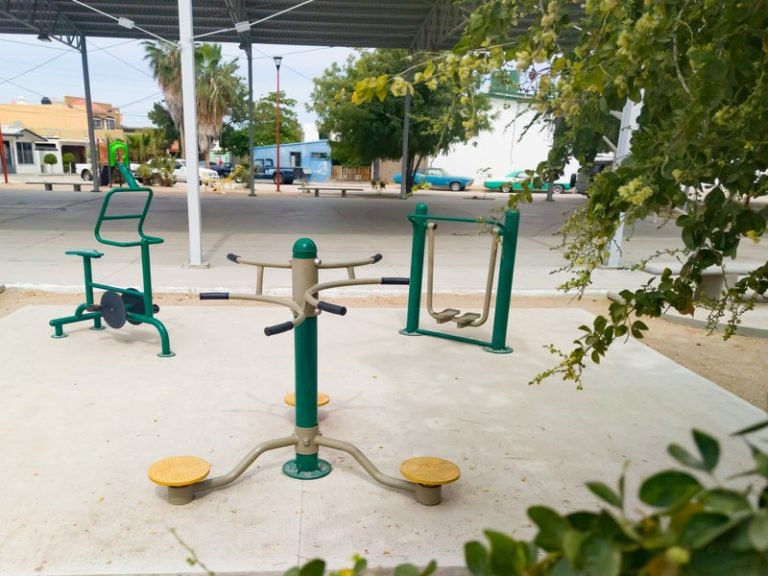 Outdoor inclusive playground with fitness equipment, providing accessible play and exercise for all abilities.