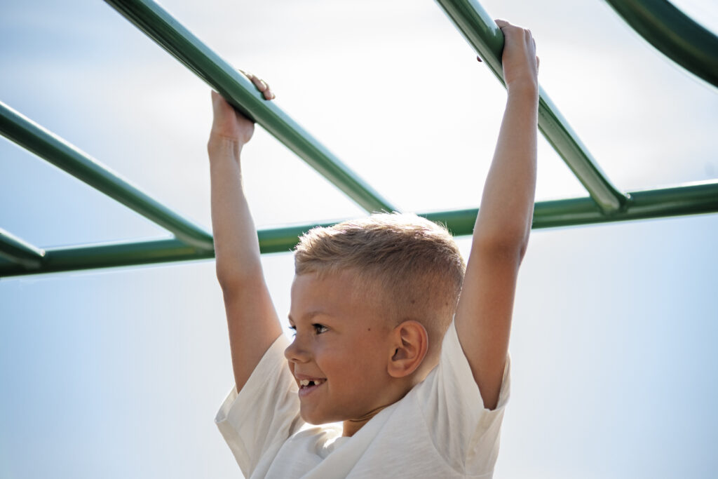 young child having fun outdoors Jungle gym